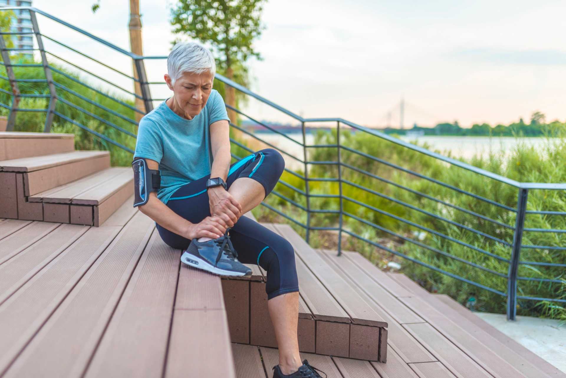 Elderly-woman-holding-ankle-in-pain-strain-vs-sprain