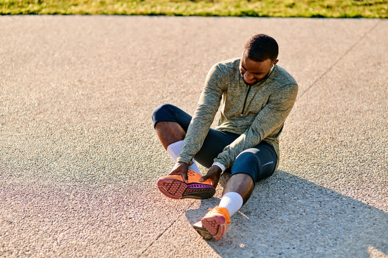 man-touching-his-heel-in-pain