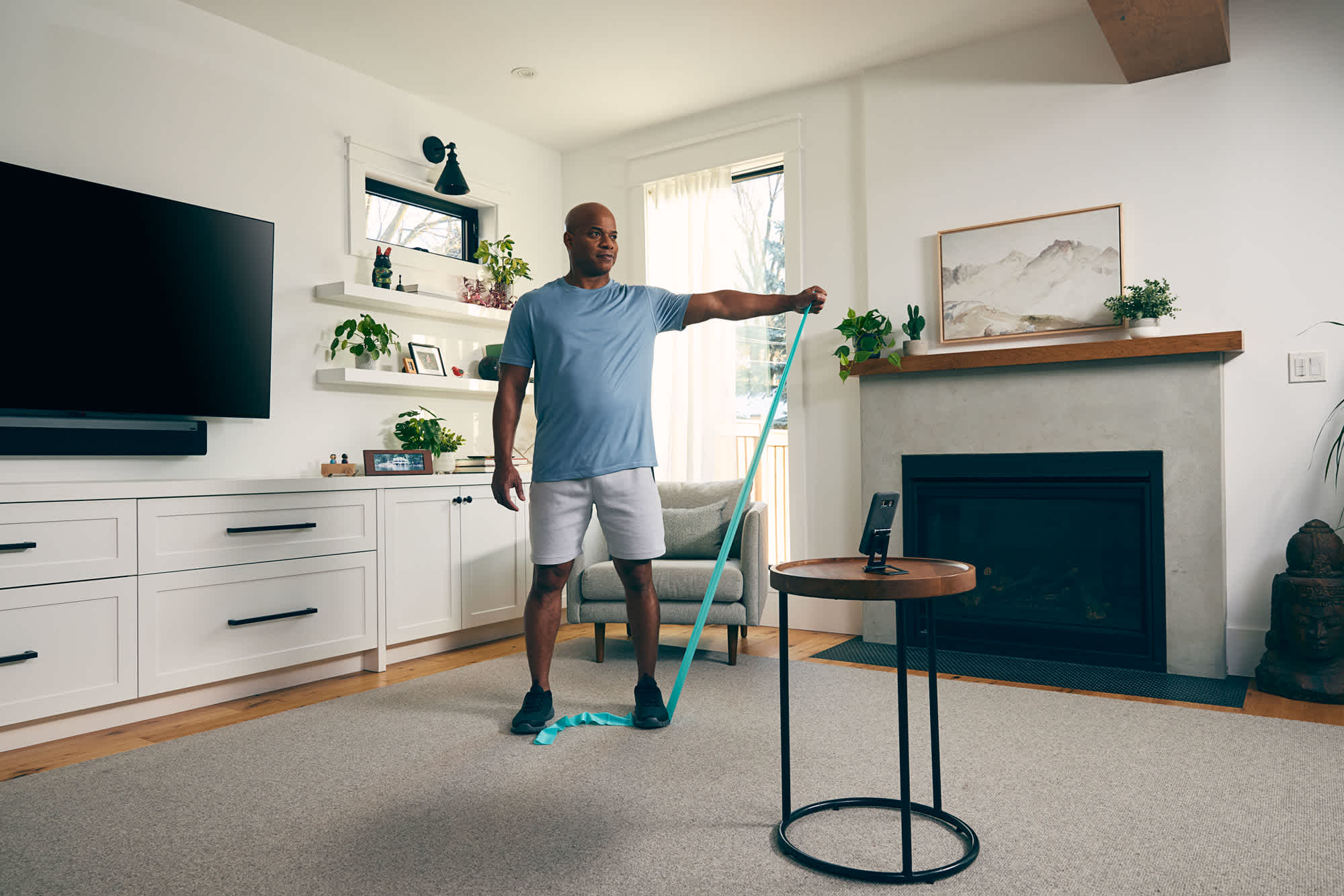 Man-doing-shoulder-rotations-with-resistance-band-at-his-house