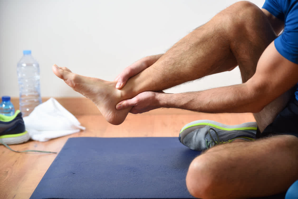 man-feeling-his-ankle-popping-after-exercising