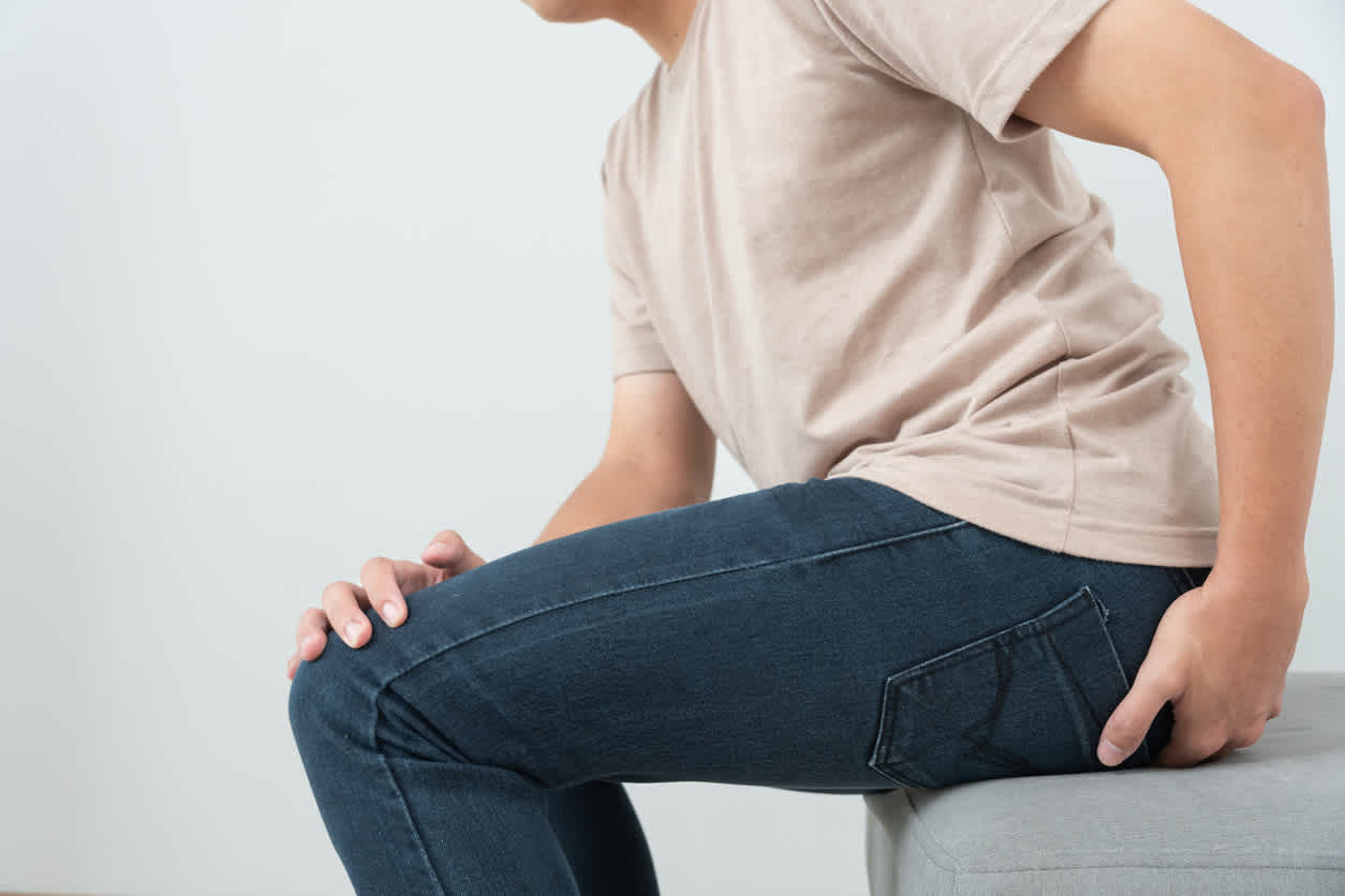 man-siting-and-touching-hip-with-pain