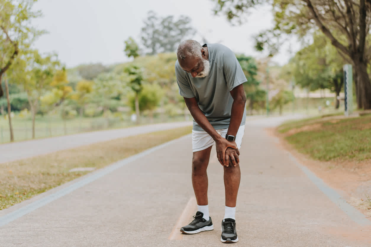 man-standing-holding-his-knee-because-of-pain