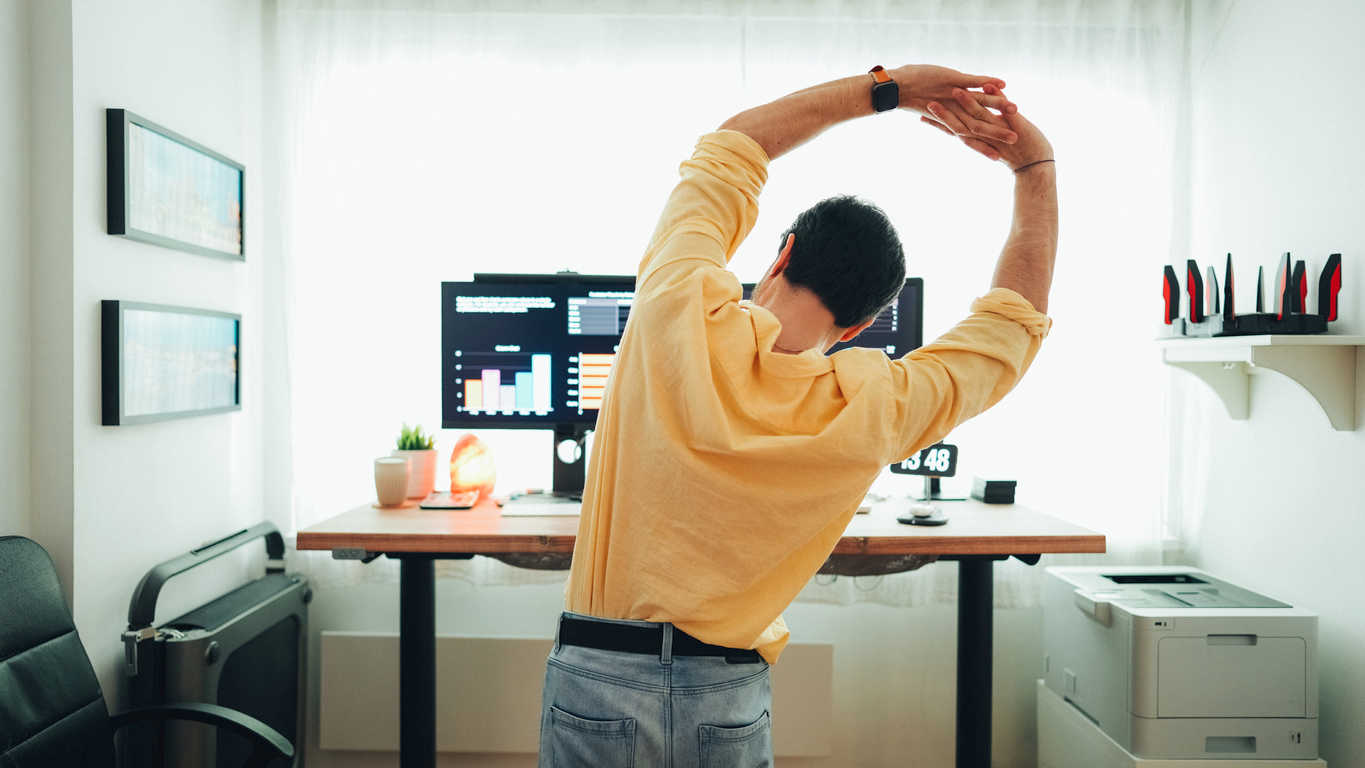 man-stretching-in-front-of-computer
