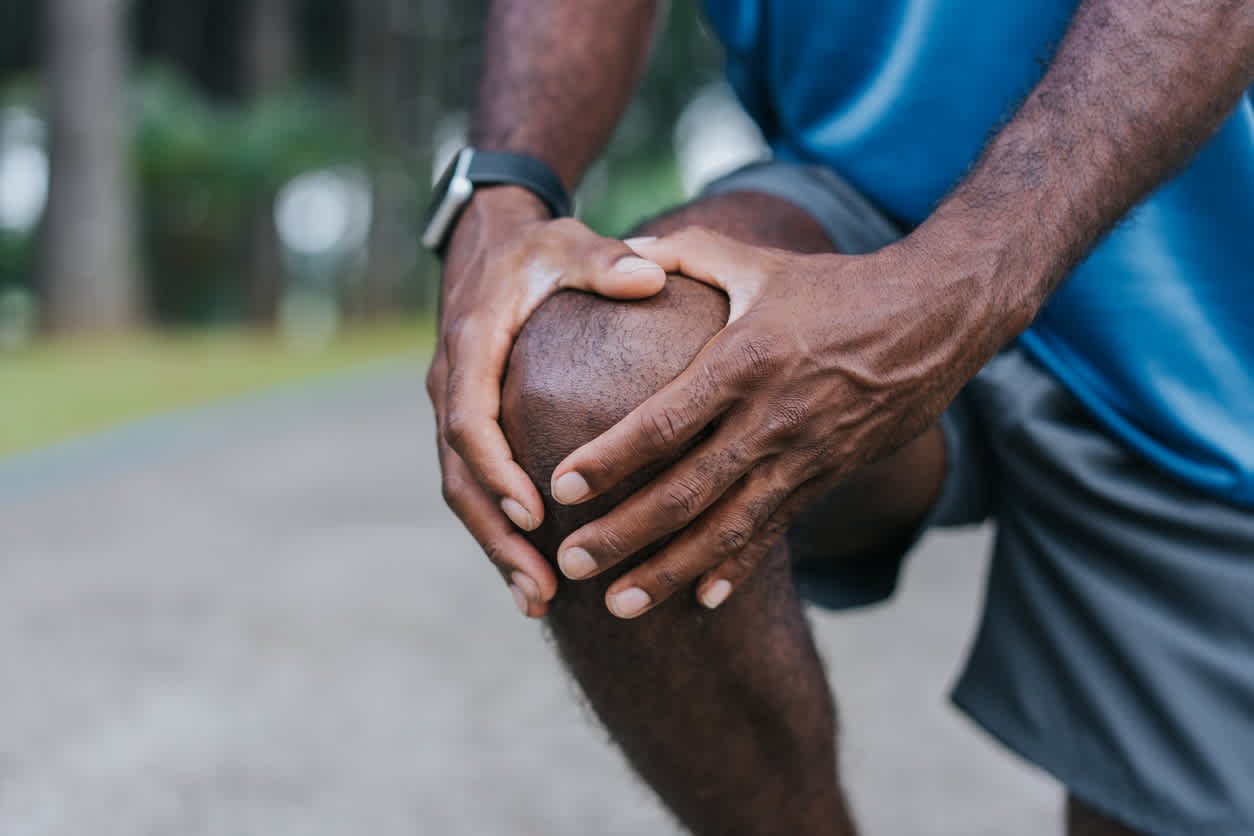 man-touching-his-knee-while-training