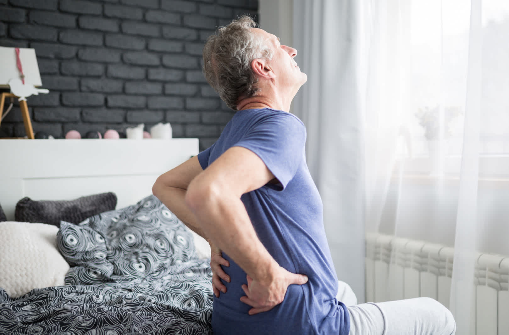 older-man-holding-his-lower-back-in-pain-after-waking-up
