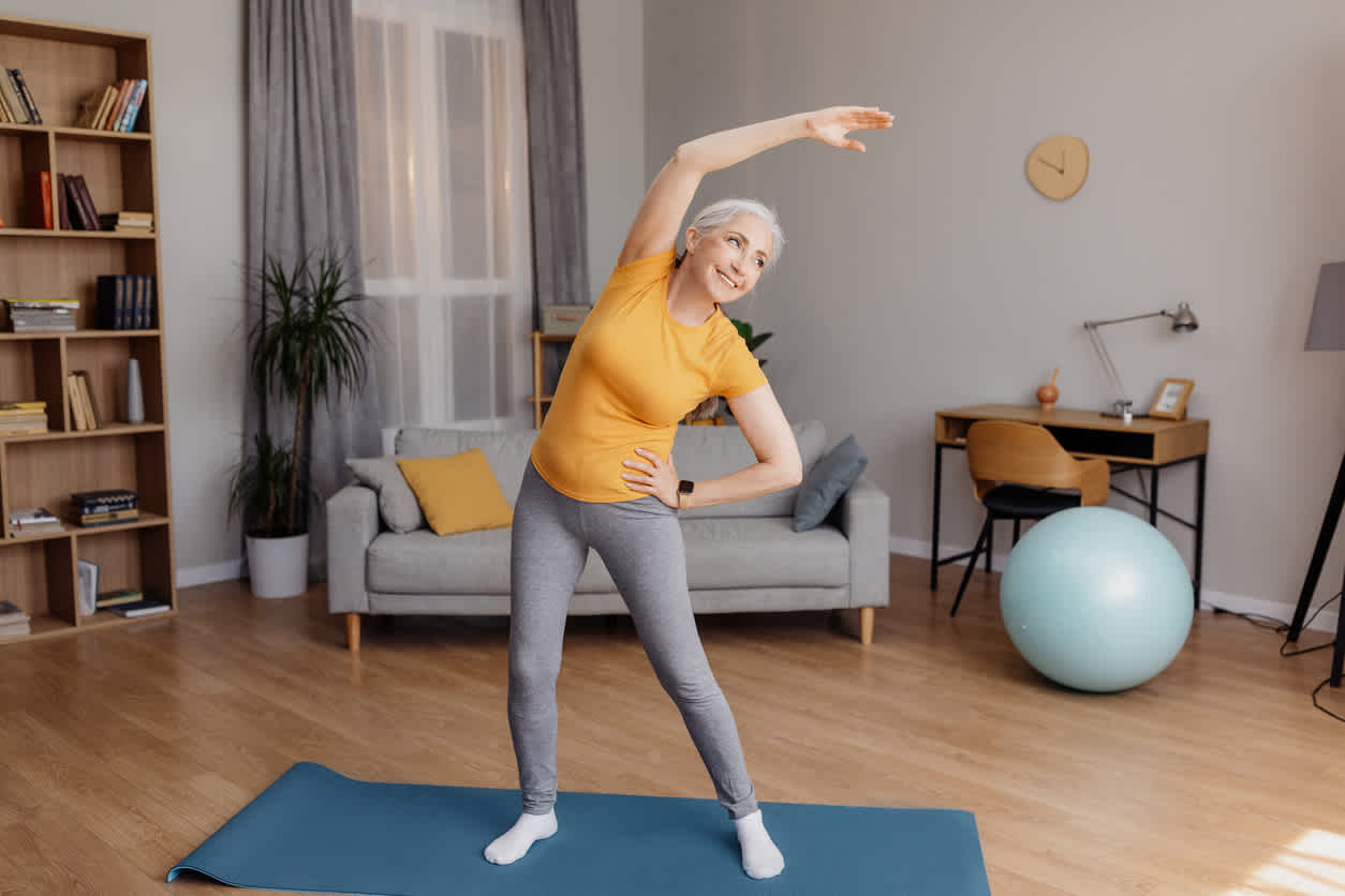 Senior woman doing exercises for lower back pain