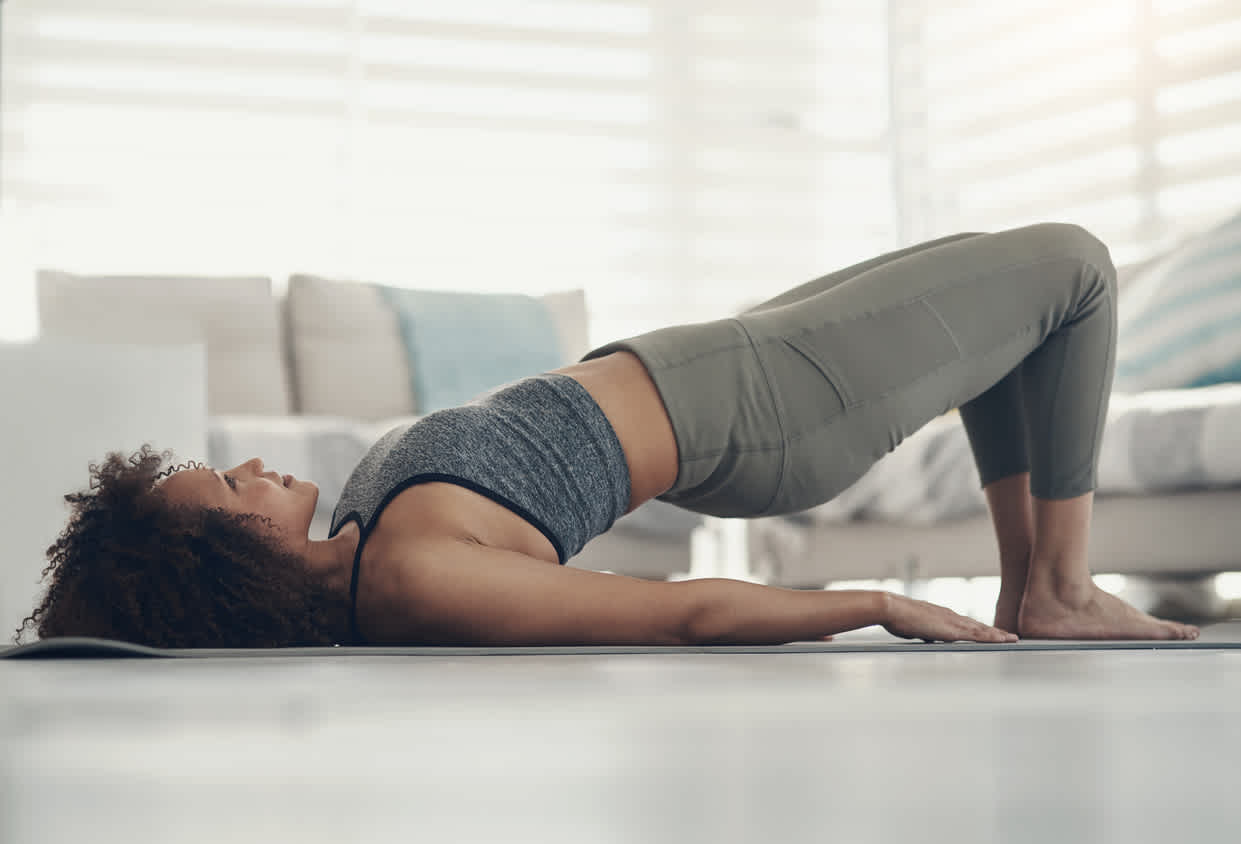 woman-laying-on-the-floor-lifting-her-pelvis-doing-the-bridge-exercise