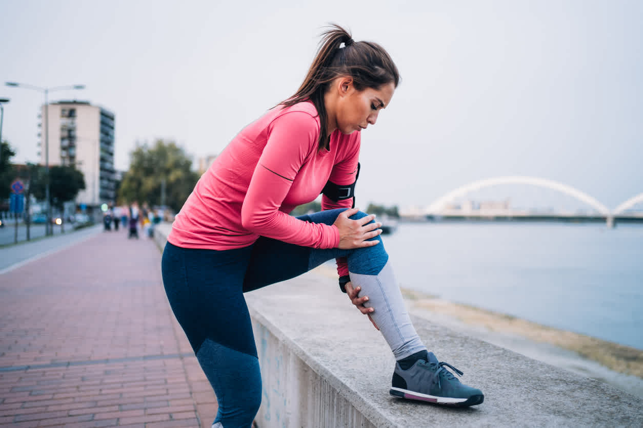 woman-streching-her-leg-while-running