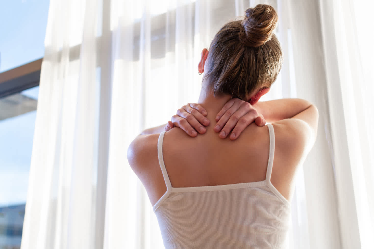 woman-stretching-holding-upper-back