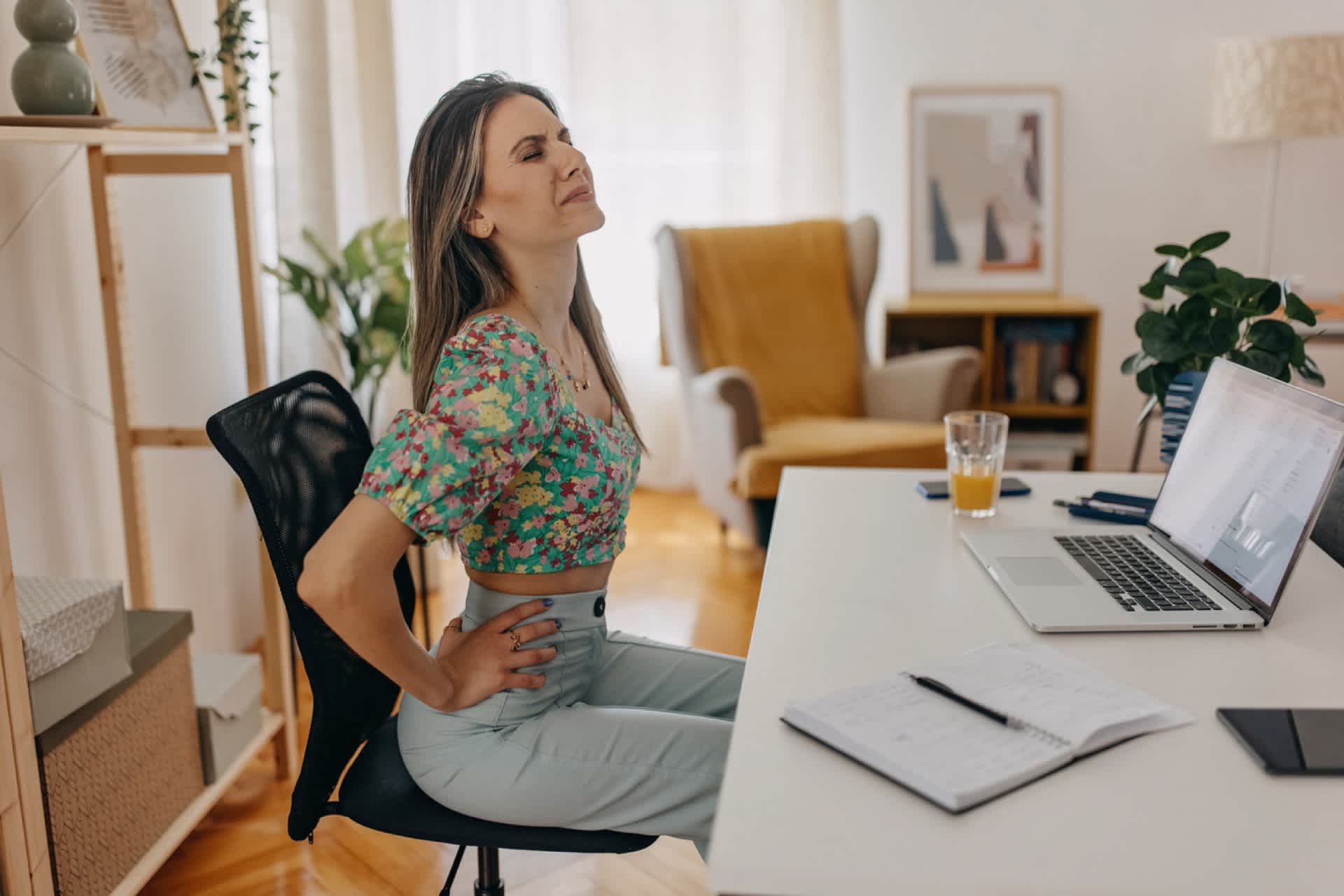 Woman-with-back-pain-sitting-down-lower-back-pain-that-radiates-to-front-pelvic-area