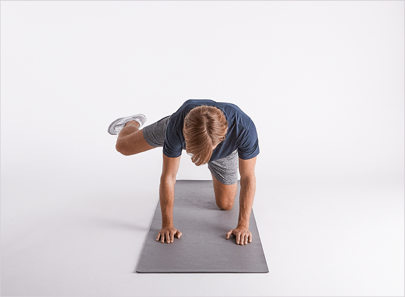 man-on-yoga-mat-doing-fire-hydrant-exercise