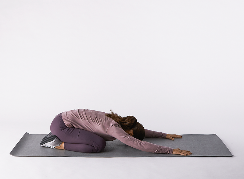 Woman-on-yoga-mat-doing-childs-pose
