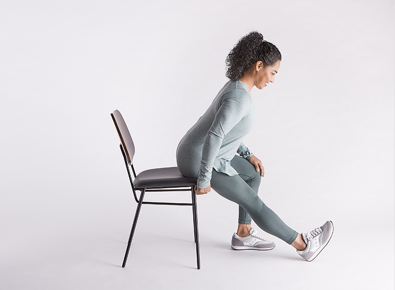 woman-sitting-in-chair-stretching-her-leg